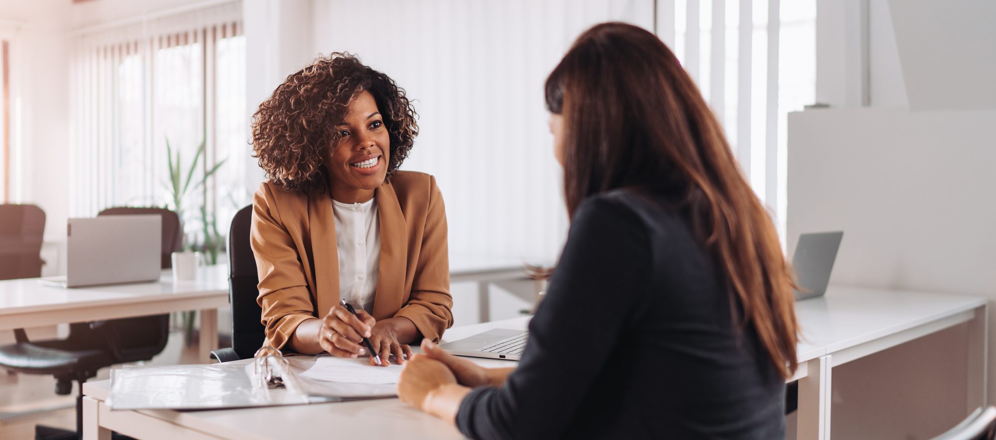 Woman consulting with a female financial manager at the bank.